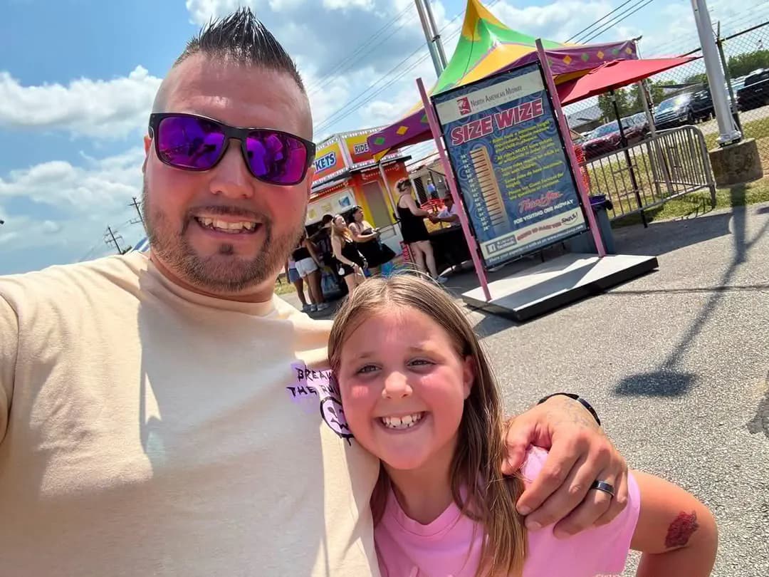 Tony and his daughter at a summer fair