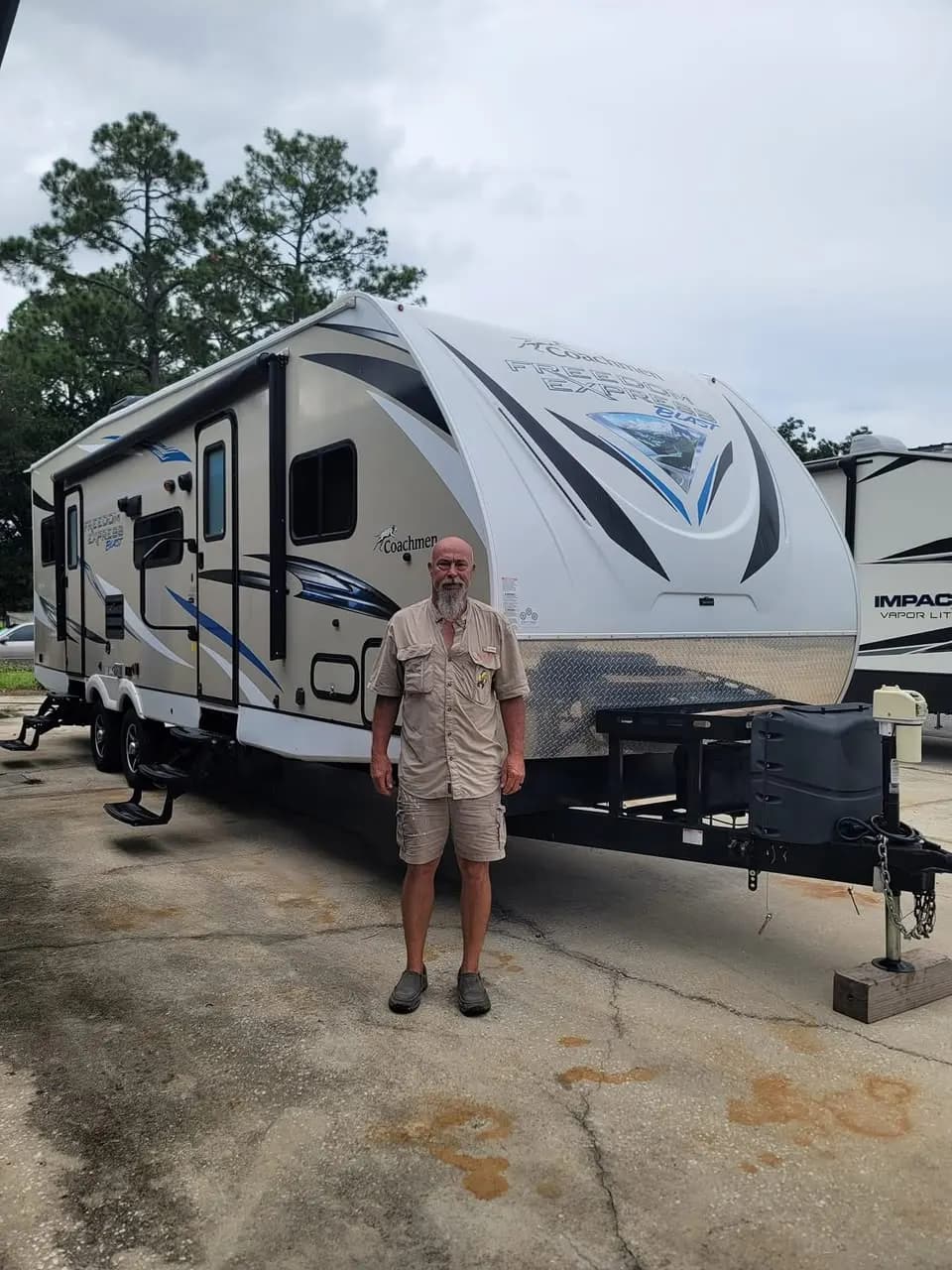 Customer in front of his Coachmen Freedom Express Blast travel trailer