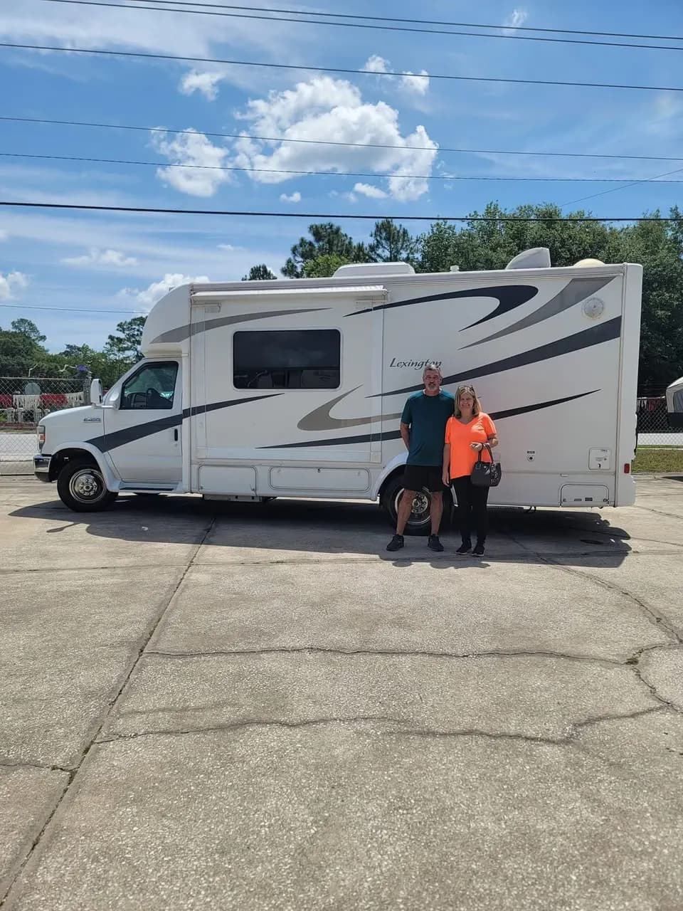 Couple in front of their Forest River Lexington motorhome